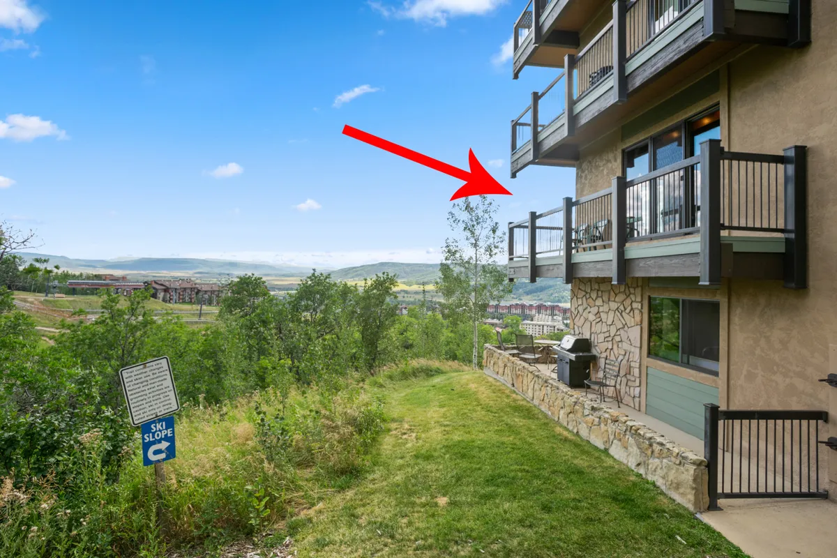 A balcony scene featuring a grill, comfortable seating, and a panoramic view of the mountains and ski slopes. The tranquil setting is ideal for enjoying sunrises, stargazing, or relaxing after a day outdoors.